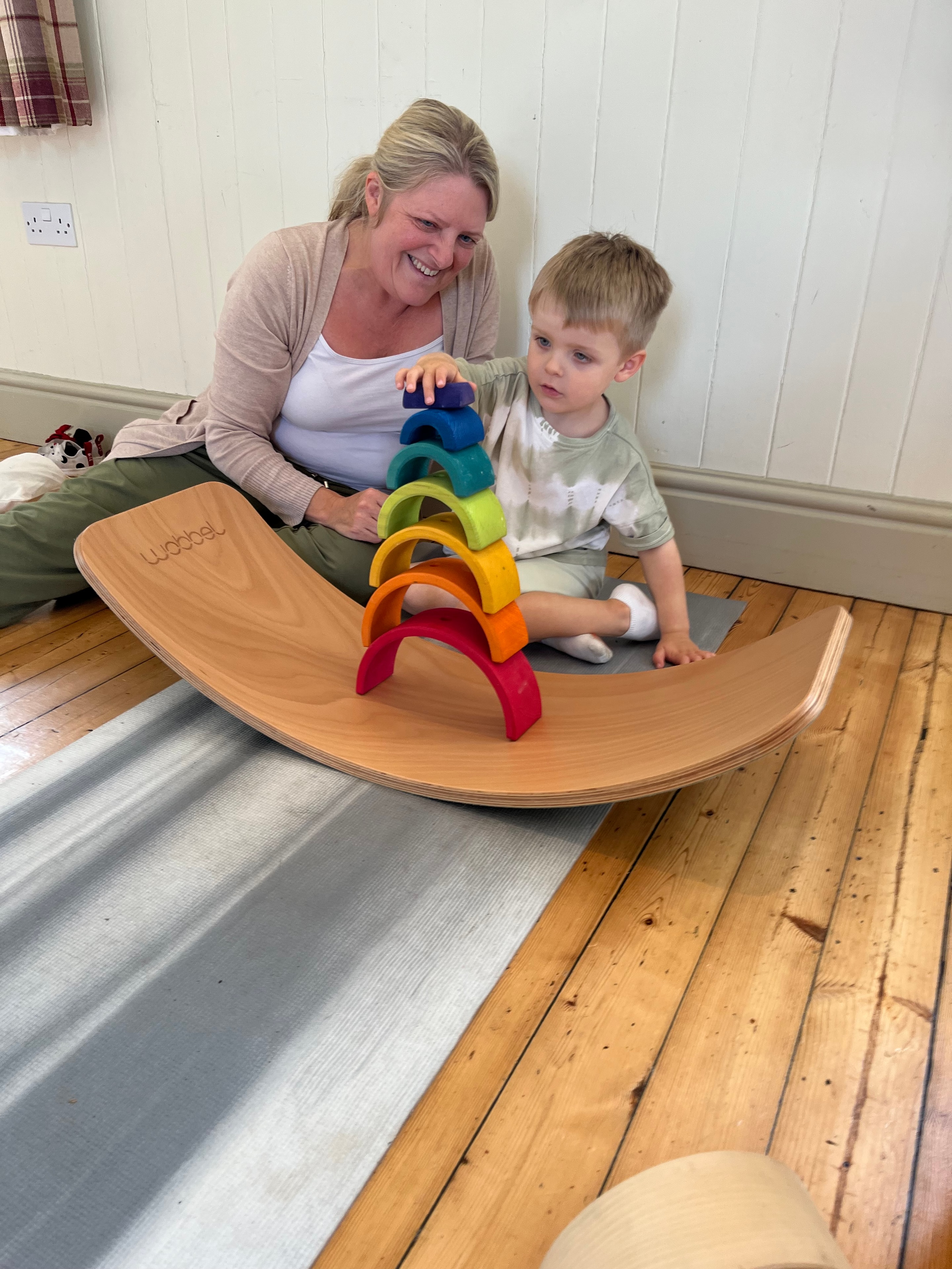 Dad playing with his toddler on a Wobbel board at Buddha Bears